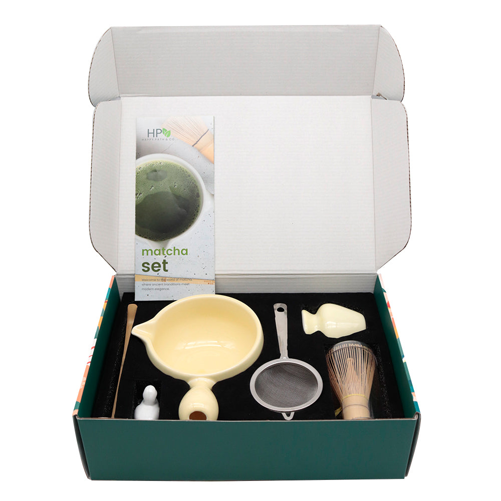 Matcha set with tools and packaging in an open box on a white background