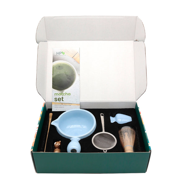 Matcha set with tools and packaging in an open box on a white background