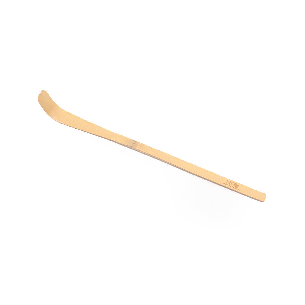 Wooden tool bamboo scoop with a curved blade on a white background
