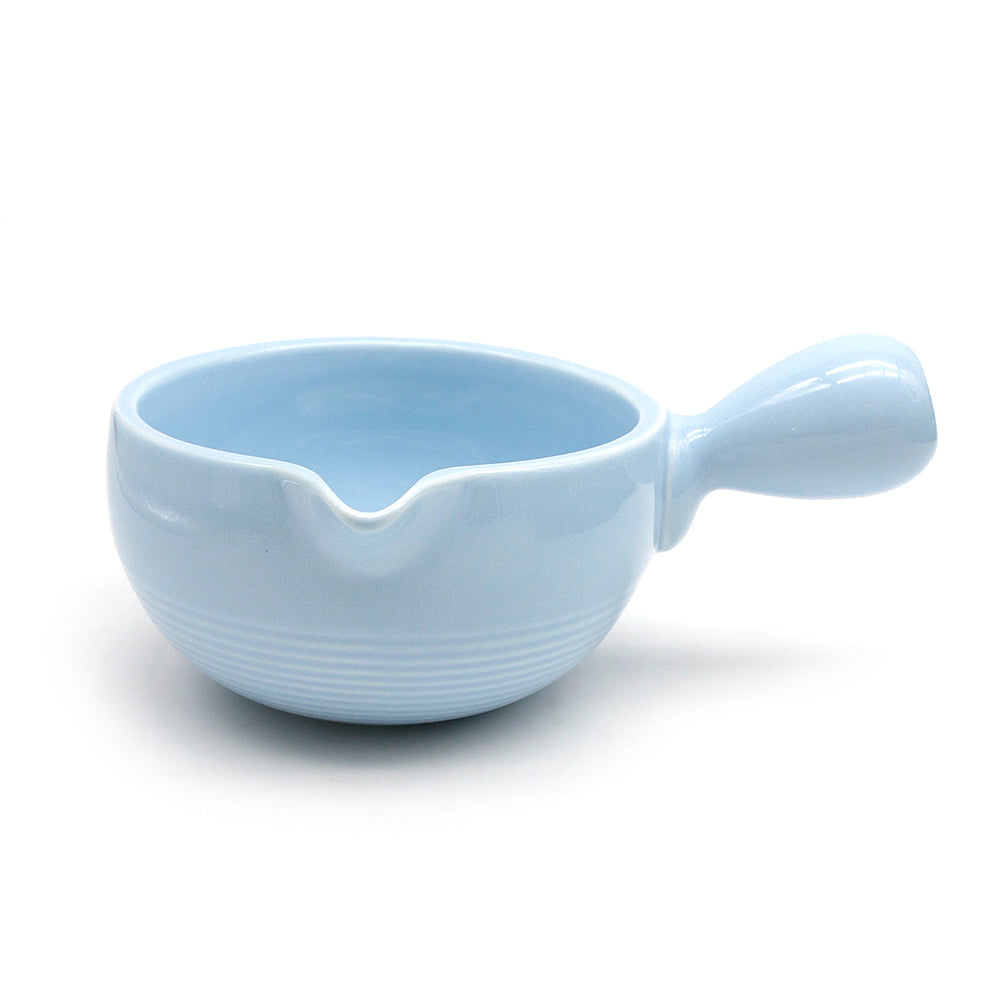 Light blue ceramic matcha bowl chawan with handle on a white background