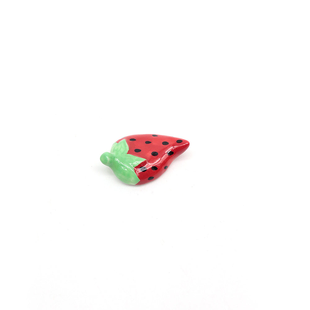 ceramic Strawberry-shaped scoop stand on a white background