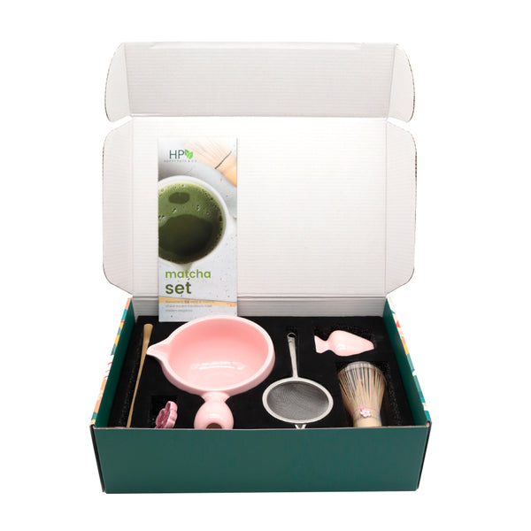 Matcha set with pink whisk, pink bowl, and other tools in a gift box with HP matcha set packaging.