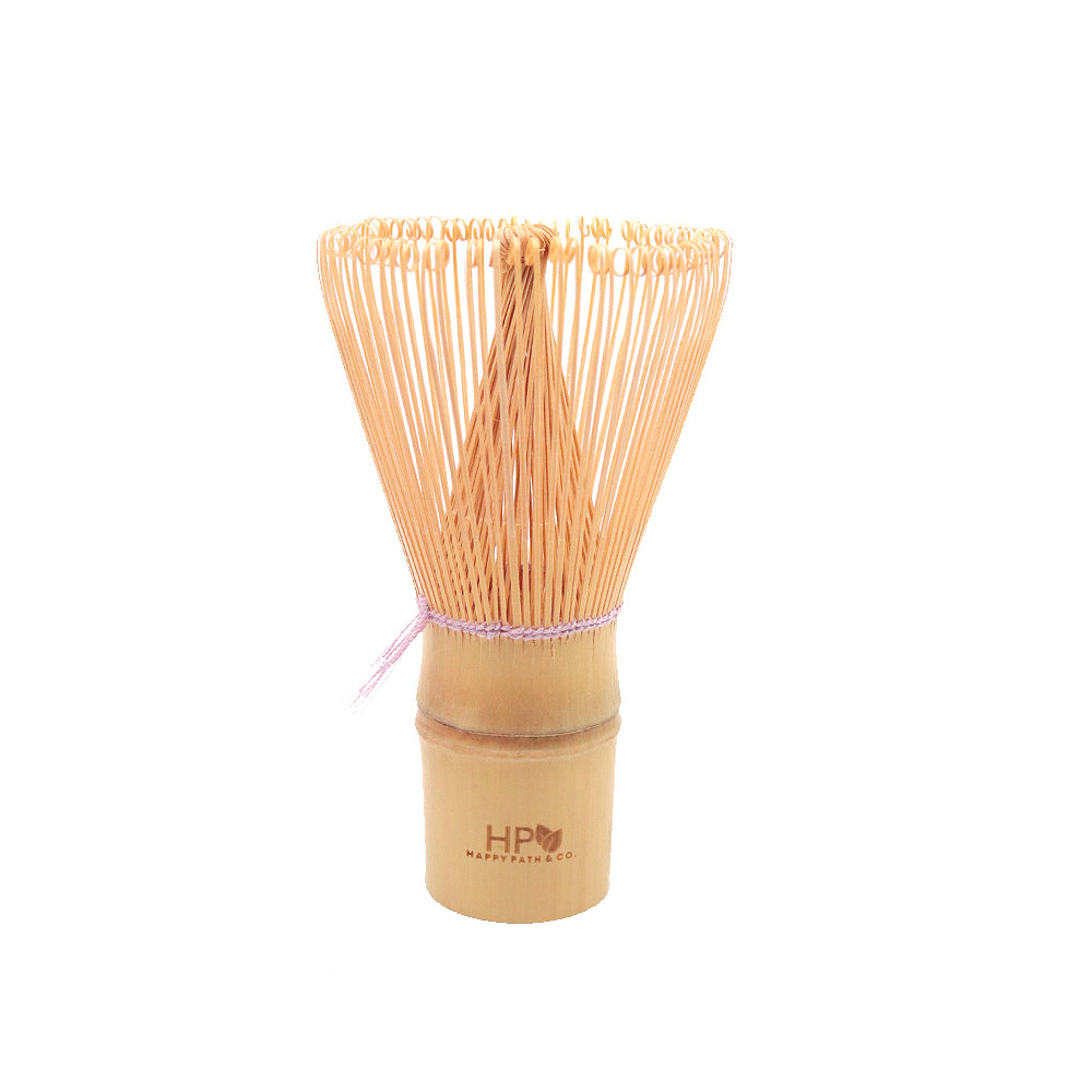 Bamboo whisk with wooden handle and purple string on a white background