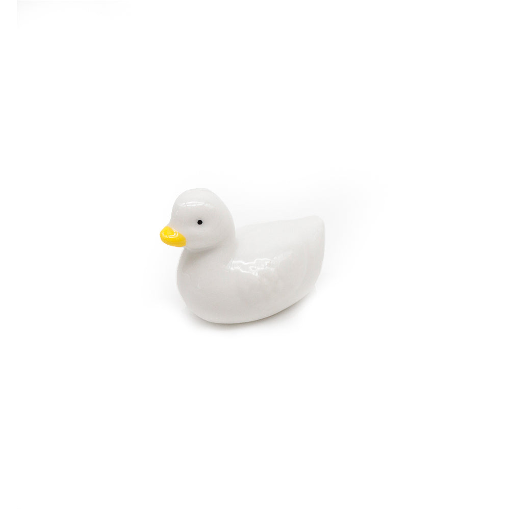 White ceramic scoop stand duck on a white background