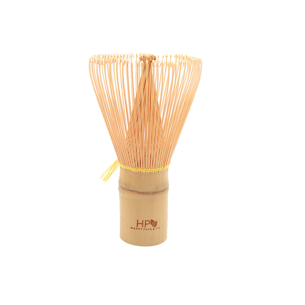 Bamboo whisk with wooden handle and yellow string on a white background