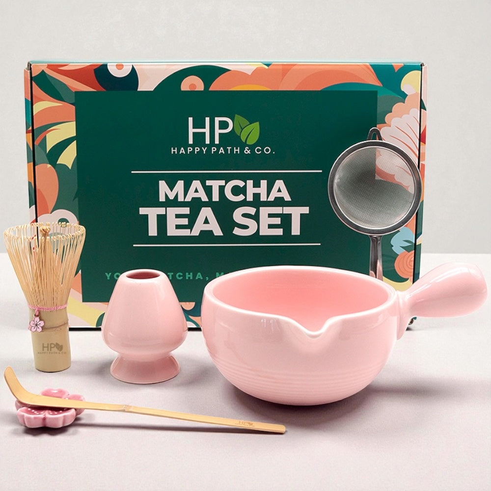 Matcha tea set with pink matcha bowl, whisk, scoop, sifter, and scoop stand in front of Happy Path & Co. gift box